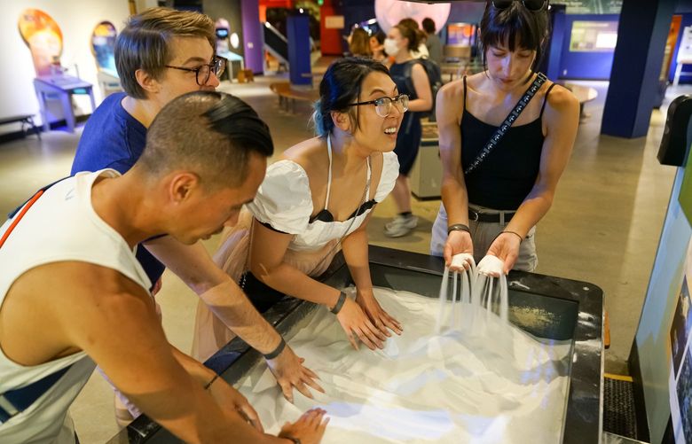 Guests can learn about Pacific Northwest watersheds at the interactive augmented reality sand table at Pacific Science Center.