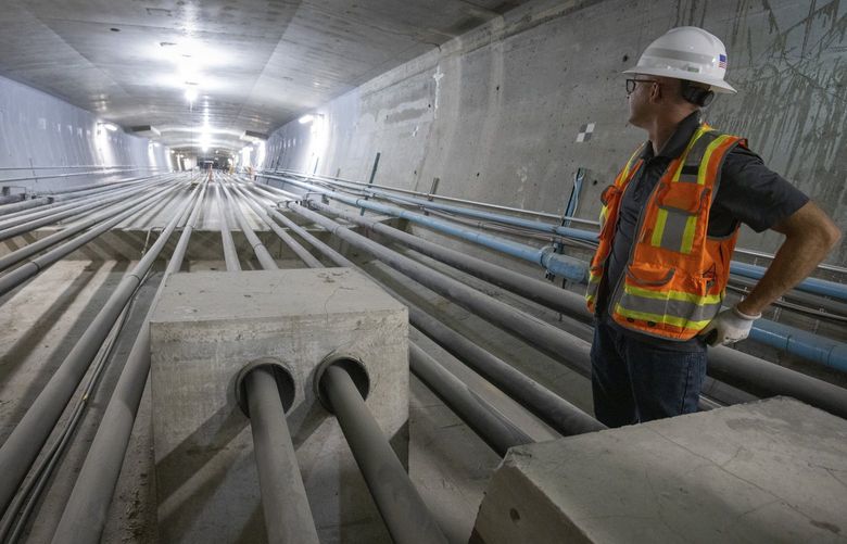 Greg Banks, a bridge engineer at WSP USA, Inc., cheks out the initial stabilization that was done inside the West Seattle bridge in 2020 in order to make sure it wouldn’t fall down. Recently two sets of cables containing post tension wires (on both side of the cables at center) were added as a final repair to make the bridge stronger. Both sets of repairs work together to strengthen the bridge.. Shot Tuesday, August 9, 2022.
221194