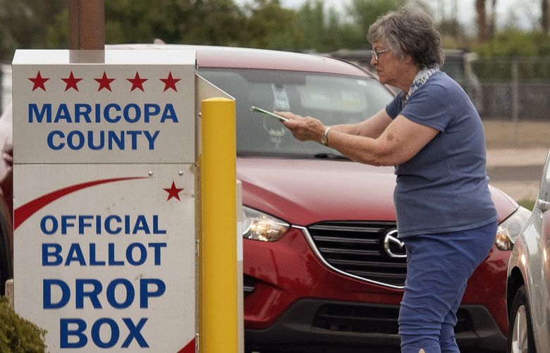 Dropping off a ballot during Arizona’s primary election in Mesa, Ariz., Aug. 2, 2022. A nascent effort to surveil drop boxes for potential fraud is taking shape in at least 10 states, worrying election officials and law enforcement. (Rebecca Noble / The New York Times) XNYT43
