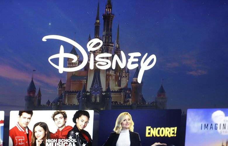 FILE – In this Nov. 13, 2019, photo, a Disney logo forms part of a menu for the Disney Plus movie and entertainment streaming service on a computer screen (AP Photo/Steven Senne, File) 