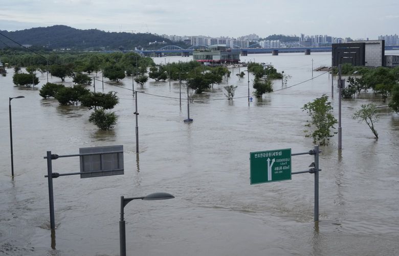A part of a park along the Han River are flooded due to heavy rain in Seoul, South Korea, Wednesday, Aug. 10, 2022. Cleanup and recovery efforts gained pace in South Korea’s greater capital region Wednesday as skies cleared after two days of record-breaking rainfall that unleashed flash floods, damaged thousands of buildings and roads and killed multiple people. (AP Photo/Ahn Young-joon) SEL105 SEL105