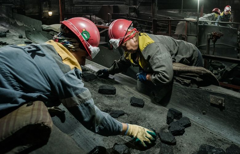 Workers sort coal in a mine in Ukraine’s eastern Donbas region, not far from the war’s front line. MUST CREDIT: Photo for The Washington Post by Wojciech Grzedzinski.