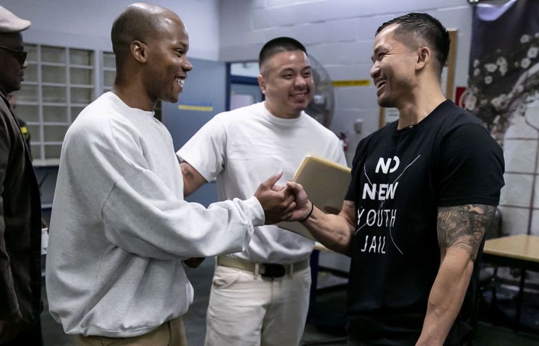 Kimonti Carter, second from left, and Felix Sitthivong, center, greet Oloth Insyxiengmay during his first visit back to Clallam Bay Corrections Center in Clallam Bay, Wash. Friday, Oct. 12, 2018. Insyxiengmay returned to Clallam Bay to attend the Black Prisoners? Caucus 2018 Youth Summit. Carter serves as president of the Black Prisoners? Caucus.  208086