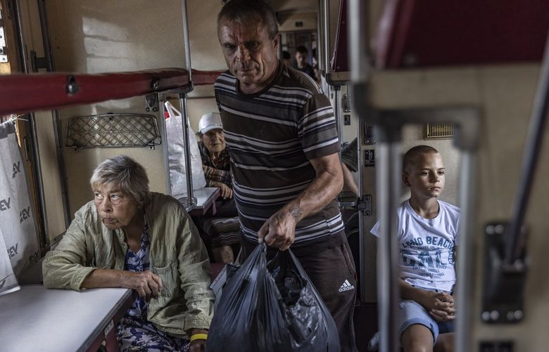 Residents of the city of Bakhmut in eastern Ukraine evacuate the area by a train bound for western Ukraine, July 31, 2022. Ukraine says that announcing a planned offensive on the southern front has paid off in the eastern Donbas region, as both sides deploy forces based on guessing each other’s next moves. (David Guttenfelder/The New York Times) XNYT204 XNYT204