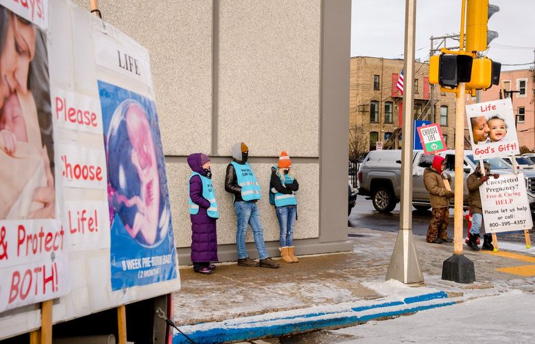 FILE — Demonstrators and clinic escorts outside the Red River Women’s Clinic in Fargo, N.D., on Nov. 7, 2018. In the wake of the Dobbs decision, trigger-law abortion bans have been temporarily blocked, reinstated, and in some cases blocked again. For providers and patients, this has meant navigating a situation in which abortion may be allowed one day and banned the next. (Hilary Swift/The New York Times)


 XNYT18