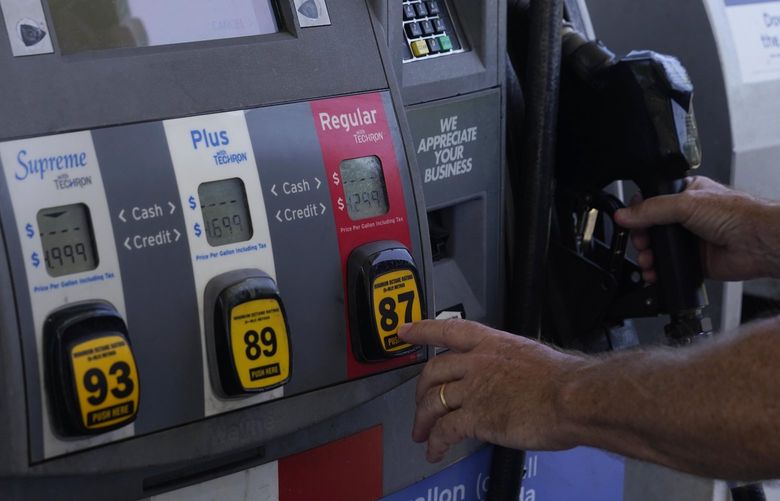 A customer pumps gas at an Exxon gas station, Tuesday, May 10, 2022, in Miami.  (AP Photo/Marta Lavandier) 