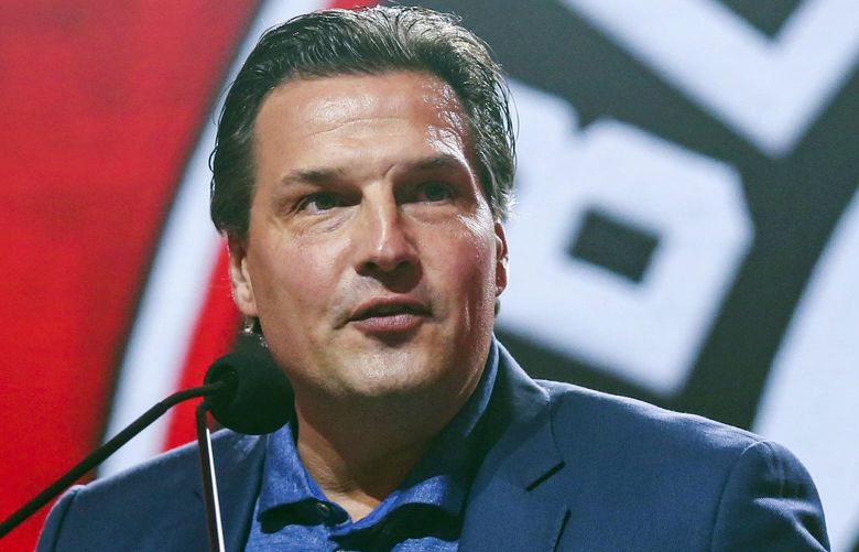 FILE – In this July 26, 2019, file photo, former Chicago Blackhawks player Eddie Olczyk speaks during the NHL hockey team’s convention in Chicago. Now more than 24 months since being declared cancer free, Olczyk is the NHL’s 2019 Hockey Fights Cancer ambassador and released a book to tell his story. He beat cancer but wants to help others dealing with (AP Photo/Amr Alfiky, File)