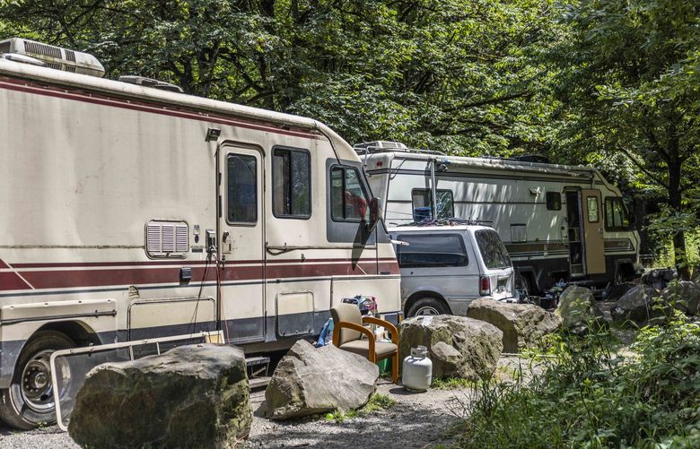 RVs and cars are parked along the Green River on July 8, 2022.