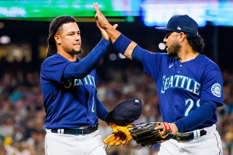 Seattle Mariners starting pitcher Luis Castillo high-fives third baseman Eugenio Suarez after finishing out the eighth inning against the Yankees, Tuesday, Aug. 9, 2022, in Seattle. (Jennifer Buchanan / The Seattle Times)