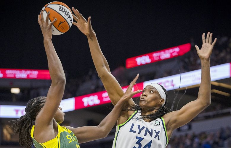 Minnesota Lynx center Sylvia Fowles (34) blocks a shot from Seattle Storm’s Tina Charles during the second quarter of a WNBA basketball game Friday, Aug. 12, 2022, in Minneapolis. (Elizabeth Flores/Star Tribune via AP) MNMIT323