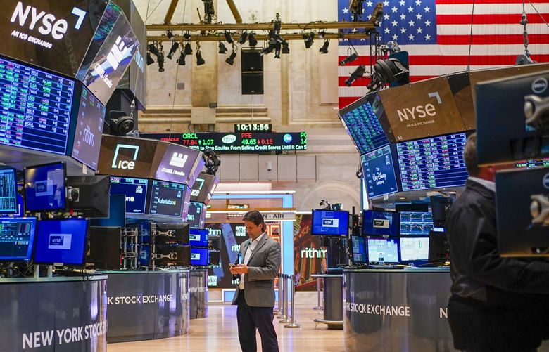 Traders work on the floor at the New York Stock Exchange in New York, Wednesday, Aug. 10, 2022. (AP Photo/Seth Wenig) NYSW103