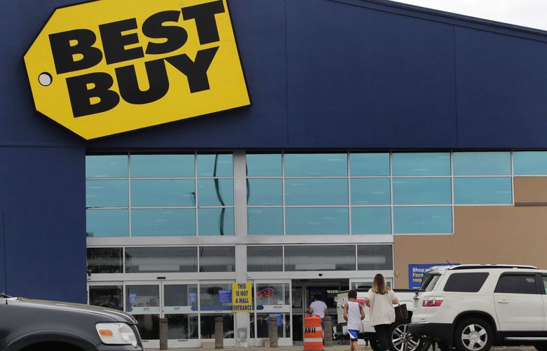 FILE – A woman walks with a boy to the Best Buy store at the Mall of New Hampshire, Tuesday, Aug. 4, 2020, in Manchester, N.H. (AP Photo/Charles Krupa, File) 