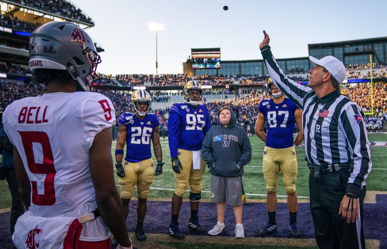 Referee Mark Duddy tosses the ceremonial pregame coin into the air before Friday’s Apple Cup. The Washington State Cougars played the Washington Huskies in the 2019 edition of the Apple Cup game at Husky Stadium in Seattle, WA Friday, November 29, 2019. 212245