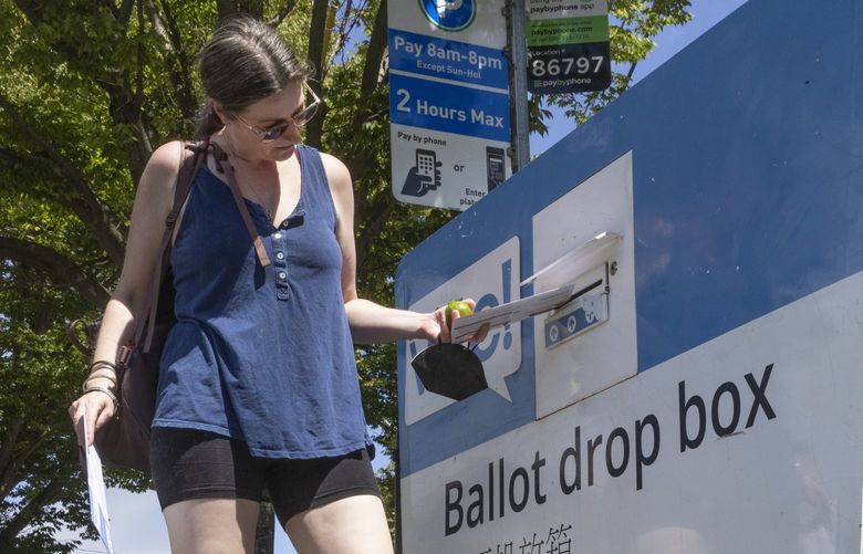 Shirlee Grund drops her ballot into the ballot drop box near the intersection of 6th Ave. S. And S. Dearborn St. in Seattle Tuesday, August 2, 2022.  Tuesday is Primary Election Day in Washington state.   221161