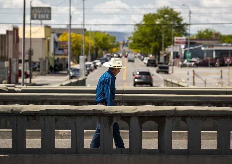 A man walks in downtown Pasco in May  2021. Some of the state’s hottest areas, like the Tri-Cities, have also seen the biggest population growth over the last two decades.
(Amanda Snyder / The Seattle Times)