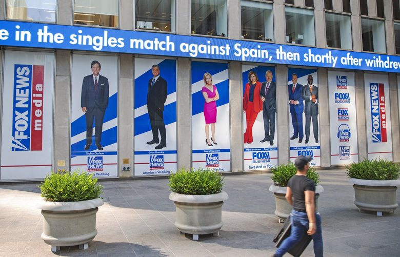 Pictured in promotional posters outside Fox News studios at News Corporation headquarters in New York on Saturday, July 31, 2021, are hosts Tucker Carlson, Sean Hannity, Laura Ingraham, Maria Bartiromo, Stuart Varney, Neil Cavuto and Charles Payne. (AP Photo/Ted Shaffrey)