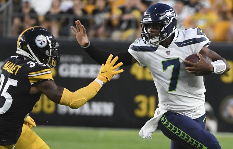 Seattle Seahawks quarterback Geno Smith (7) tries to break away from Pittsburgh Steelers cornerback Arthur Maulet (35) on a long scramble during the first half of a preseason NFL football game, Saturday, Aug. 13, 2022, in Pittsburgh. (AP Photo/Barry Reeger) PAKS125 PAKS125