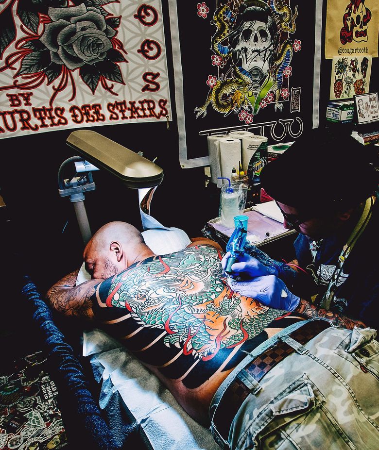 A tattoo artist at Hidden Hand Tattoo works on a design in this undated photo. (Courtesy Hidden Hand Tattoo)