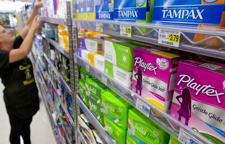 Feminine hygiene products are seen as Tammy Compton restocks a shelf at Compton’s Market, Wednesday, June 22, 2016, in Sacramento, Calif. A bill co-authored by Assemblywomen Cristina Garcia, D-Bell Gardens and Ling Ling Chang, R-Diamond Bar, to exempt tampons and other feminine hygiene products from sales tax was approved by the Senate Governance and Finance committee Wednesday.(AP Photo/Rich Pedroncelli) SC103