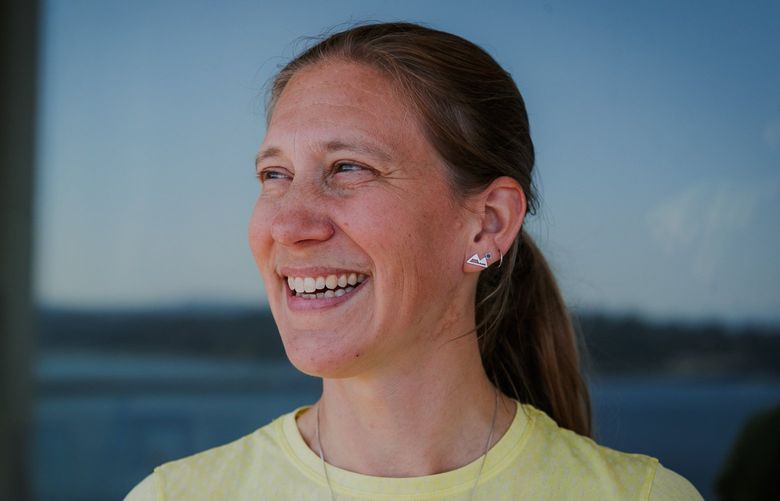 Seattle run coach Trisha Steidl poses for a portrait at her home on Lake Washington in Seattle on August 11, 2022. Steidl is the first person to summit all five of Washington’s volcanoes in just five days. 221137