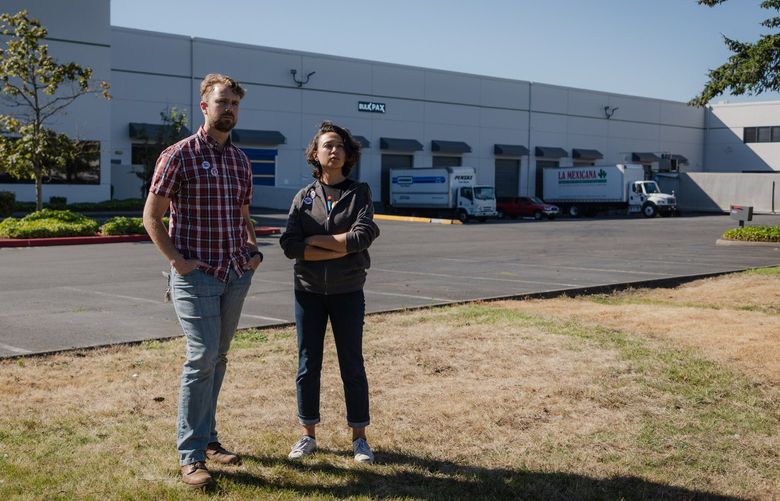 Homegrown delivery drivers Manya Janowitz, 29, right, and Trevor Taylor, 36, pose for a portrait outside a warehouse used by the company in Renton, WA on August 16, 2022. Janowitz and Taylor say Homegrown is retaliating against workers requests for raises and better benefits by installing surveillance technology in their trucks. 221308
