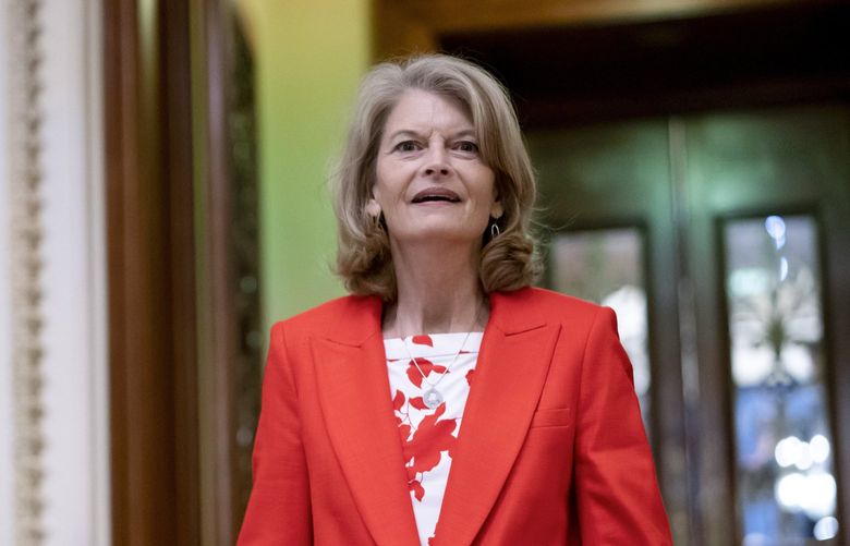 FILE – Sen. Lisa Murkowski, R-Alaska smiles as she leaves the Senate chamber, at the Capitol in Washington, April 5, 2022. Murkowski is seeking reelection to a seat she has held for nearly 20 years. She faces 18 opponents, the most prominent of which is Republican Kelly Tshibaka, who has been endorsed by former President Donald Trump. (AP Photo/J. Scott Applewhite, File) WX212 WX212