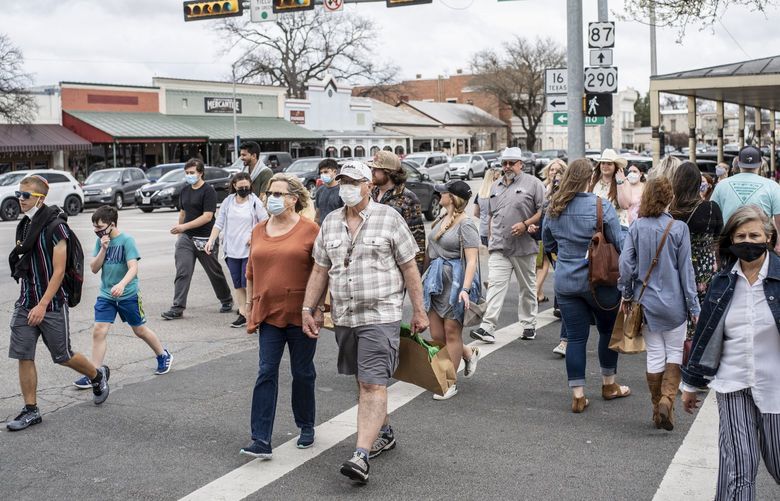 FILE — Pedestrians in Fredericksburg, Texas, March 13, 2021. The recent resignations of all three election officials in a Texas county — at least one of whom cited repeated death threats and stalking — has created turmoil in an area that President Donald Trump won by 59 percentage points in 2020. (Matthew Busch/The New York Times) XNYT169 XNYT169