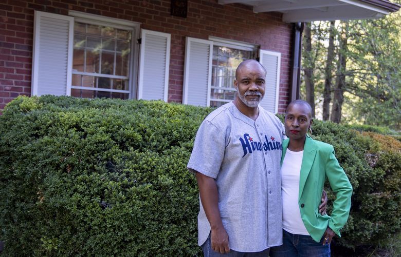 Nathan Connolly and Shani Mott at their home in Baltimore on Aug. 16, 2022. They are suing an appraiser and a mortgage lender after their home was estimated to be worth $472,000. After the couple removed any indications that Black people lived there, a second appraiser valued the home at $750,000.  (Shan Wallace/The New York Times)