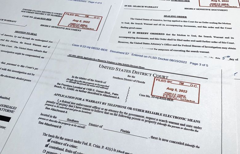 Documents related to the search warrant for former President Donald Trump’s Mar-a-Lago estate in Palm Beach, Fla., are photographed Thursday, Aug. 18, 2022. U.S. Magistrate Judge Bruce Reinhart agreed to make public documents, including the warrant’s cover sheet, the Justice Department’s motion to seal the documents and the judge’s order requiring them to be sealed. (AP Photo/Jon Elswick) DCJE322 DCJE322