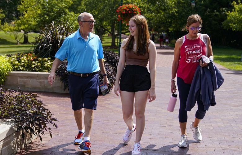 Emily Korenman, freshman, 18, center, from Dallas, walks with her parents Wendy and Phillip through campus at Indiana University in Bloomington, Ind., Tuesday, Aug. 16, 2022. Korenman, who decided to study business at Indiana University, said she was frustrated to learn her new state passed new abortion restrictions that take effect Sept. 15 and allow limited exceptions. The 18-year-old said it didn’t change her mind about attending a school she really likes, but she isnâ€™t sure what she would do if she became pregnant during college. (AP Photo/Michael Conroy) INMC201 INMC201
