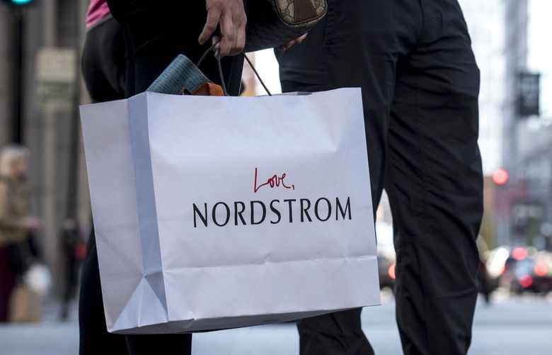 A pedestrian carries a Nordstrom Inc. shopping bag in Chicago, in 2016. (Christopher Dilts/Bloomberg)