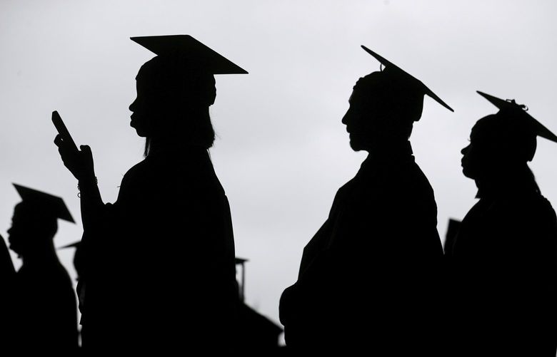 FILE – New graduates line up before the start of a community college commencement in East Rutherford, N.J., on May 17, 2018.  (AP Photo/Seth Wenig, File) 