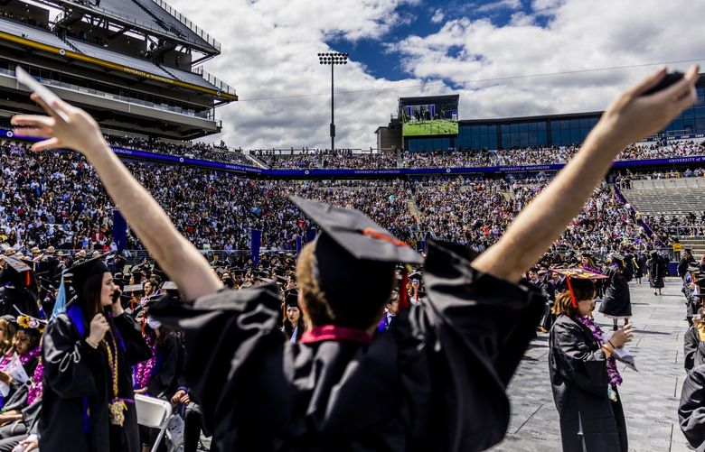 Graduates wave to a sea of family and friends watching commencement at Husky Stadium at the University of Washington in Seattle on June 11, 2022.