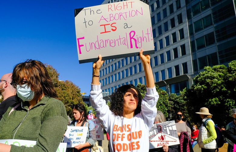 Rosamaria Cavalho holds a sign during a May 3 abortion rights protest in San Francisco.