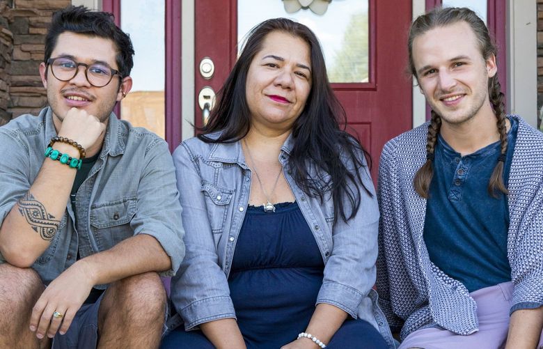 From left, Irwing Bernal, his mother, Blanca Moye, and his fiance, Ricky Kairos, at the home in Victor, Idaho, that they all share. The couple lives with Bernal’s mother, and both work for Jackson’s public school system. MUST CREDIT: Photo for The Washington Post by Amber Baesler.