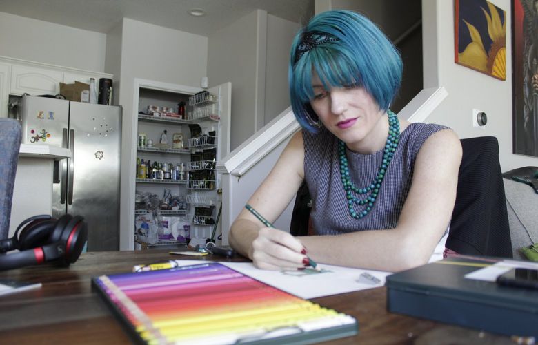 Lynn Hunt, who took out between $45,000 and $50,000 in student loans and was a Pell Grant recipient, uses colored pencil to fill in a sketch at home in Beaverton, Ore., on Wednesday, Aug. 24, 2022. Hunt says President Biden’s student loan forgiveness plan isn’t enough to help because Hunt owes about $70,000 due to a 6.7% interest rate on the loans. Hunt says the temporary moratorium on loan repayment during the COVID-19 pandemic allowed Hunt to stop working 80-hour weeks and to return to artistic hobbies. (AP Photo/Gillian Flaccus) RPGF302 RPGF302