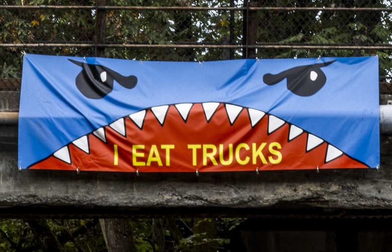 Cars whizz by a “truck eating bridge,” known for its low clearance in Kirkland on Friday, Aug. 19, 2022.