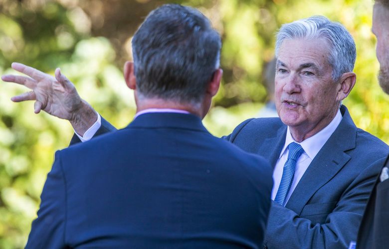 Federal Reserve Chair Jerome Powell, center, takes a coffee break with attendees of the central bank’s annual symposium at Jackson Lake Lodge in Grand Teton National Park Friday, Aug. 26, 2022. in Moran, Wyo. (AP Photo/Amber Baesler) LA503