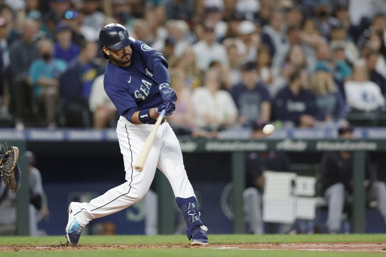 Seattle Mariners' Edgar Martinez watches his sacrifice fly to