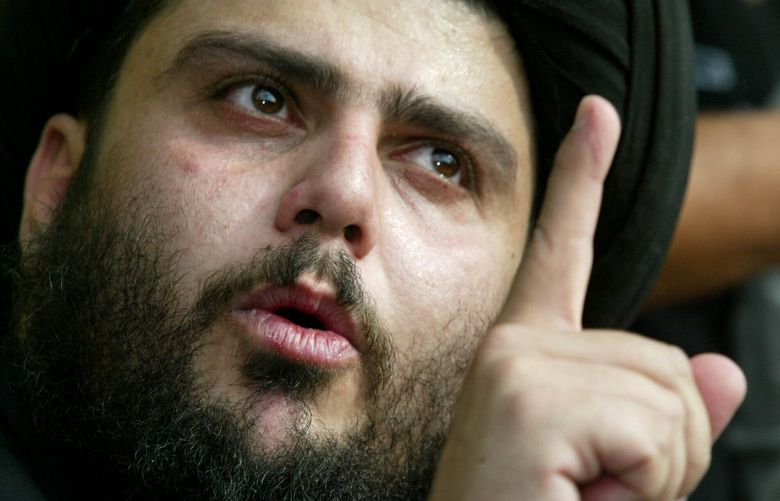 FILE – Radical Shiite Muslim cleric Muqtada al-Sadr speaks at a news conference in Najaf, 165 kilometers (100 miles) south of Baghdad, Oct. 14, 2003. Al-Sadr is a populist cleric, who emerged as a symbol of resistance against the U.S. occupation of Iraq after the 2003 invasion. (AP Photo/Greg Baker, File) NY909 NY909