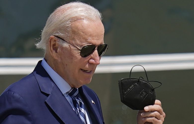 President Joe Biden removes his mask as he prepares to board Air Force One, Tuesday, Aug. 30, 2022, at Andrews Air Force Base, Md. Biden is traveling to Wilkes-Barre, Pa., to announce his crime prevention plans. (AP Photo/Patrick Semansky) MDPS104 MDPS104