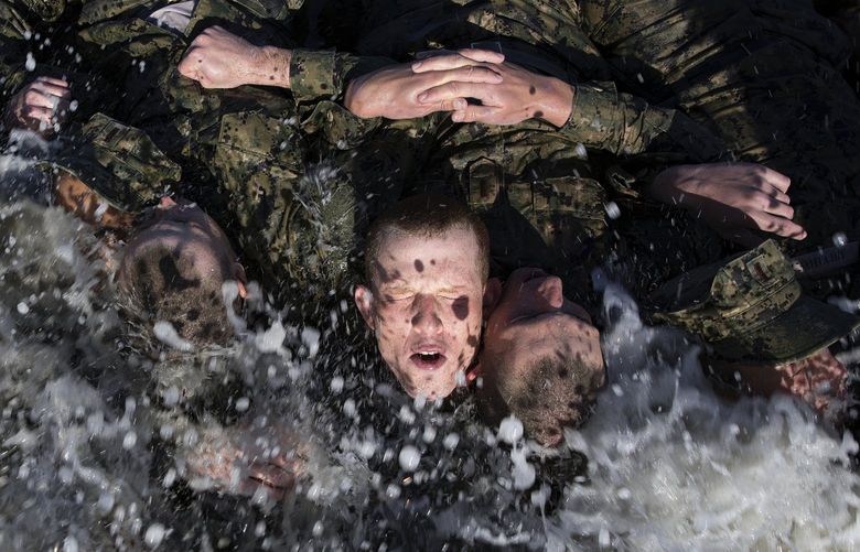 A photo provided by the Naval Special Warfare Command shows U.S. Navy SEAL candidates participating in Basic Underwater Demolition/SEAL (BUD/S) training in 2018 in Coronado, Calif. Frequent plunges in the frigid Pacific Ocean are one of the most difficult aspects of training.  (Petty Officer 1st Class Abe McNatt/Naval Special Warfare Command via The New York Times) – FOR EDITORIAL USE ONLY – XNYT97 XNYT97