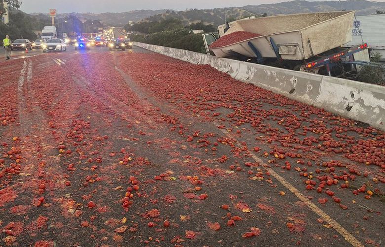 In this photo provided by the California Highway Patrol is the scene where a truck hauling a load of the tomatoes crashed after a collision near Vacaville, Calif., Monday, Aug. 29, 2022. The load spilled across several lanes of Highway 80 in Northern California. Crews had cleaned the eastbound lanes but one westbound lane remained closed six hours after the crash, the CHP said. (California Highway Patrol via AP) FX104 FX104