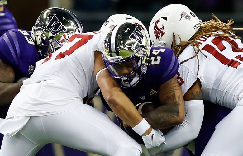 Husky Stadium – Apple Cup – University of Washington Huskies vs. Washington State University Cougars – 112621

The Washington State Cougars defense stops Washington Huskies running back Kamari Pleasant at the line of scrimmage during the third quarter Friday, Nov. 26, 2021, in Seattle. 218907