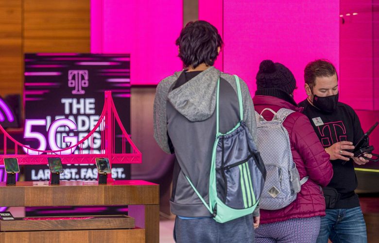 A worker checks in a customer inside a T-Mobile store in San Francisco, California, U.S., on Monday Jan. 31, 2022. T-Mobile US Inc. is scheduled to release earnings figures on Feb. 2. 775768171