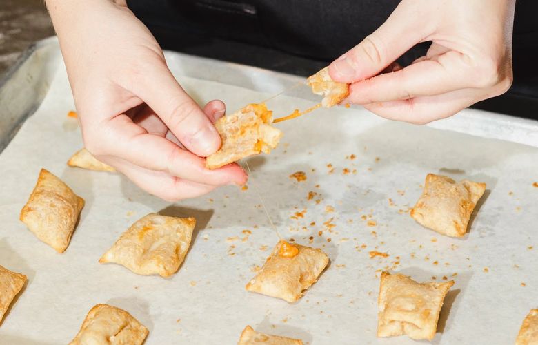Taylor May pulls apart pizza rolls in the kitchen at Ingredion.