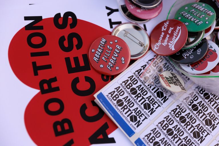 Buttons and signs are stacked during the Shout Your Abortion (SYA) gathering to protest the U.S. Supreme Court decision overturning Roe v. Wade