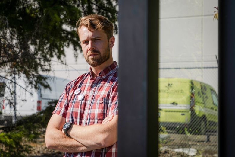 Homegrown delivery driver Trevor Taylor, 36, in Renton on Tuesday, says the company is retaliating against workers requests for raises and better benefits by installing surveillance technology in their trucks. (Kori Suzuki / The Seattle Times)