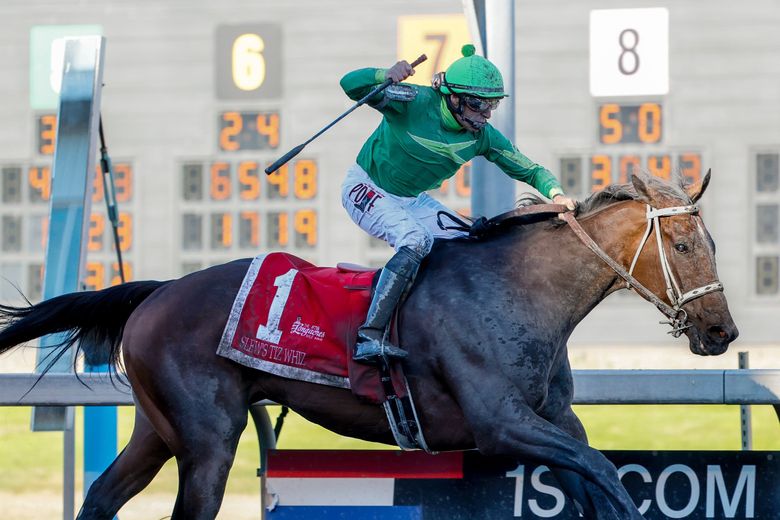 Jockey Jose Zunino aboard Slew’s Tiz Whiz celebrates at the line as he comes home in first place during the Longacres Mile at Emerald Downs on Sunday. (Jennifer Buchanan / The Seattle Times)