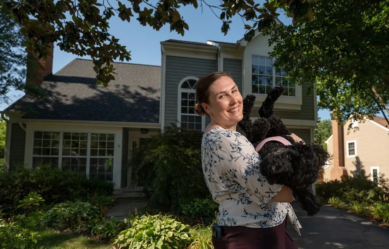 Dr. Courtney Culbreath poses for a photo with her dog Lori outside her home in Herndon, Va., on July 23, 2022. (Washington Post photo by Craig Hudson).
